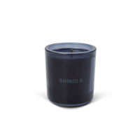 The Shinola Rhythm 8 oz Scented Candle features a dark blue recycled glass holder with "SHINOLA" on the front and a blue coconut soy single-wick candle, displayed against a plain white background.