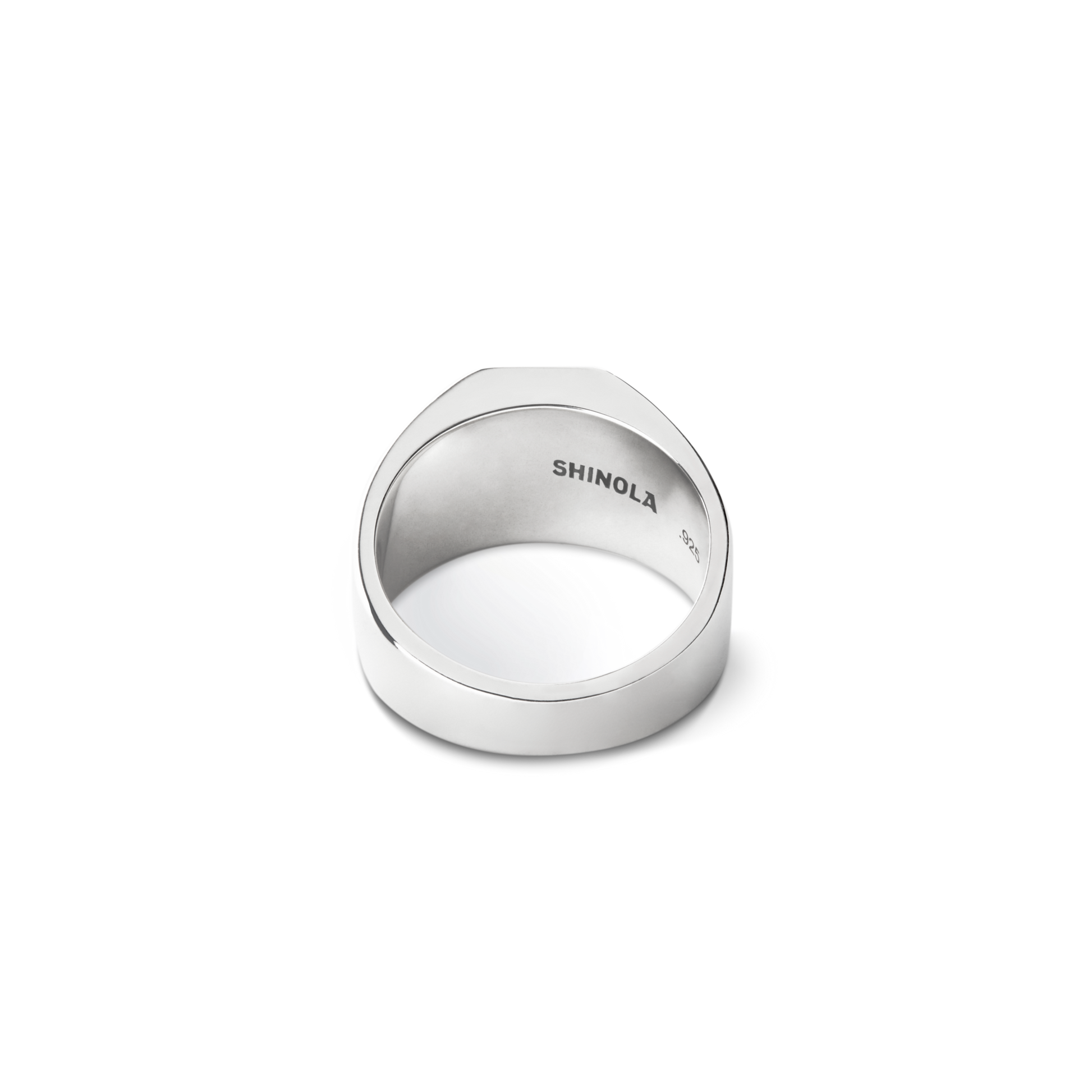 The Octagonal Lapis Signet Ring by Shinola features a flat top and inner engraving reading "SHINOLA" and "925," shown from the back against a plain white background. Crafted in sterling silver with a geometric design.