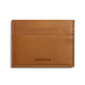The Shinola 5 Pocket Card Holder in tan vachetta leather features two card slots, clean edge stitching, and SHINOLA embossed at the bottom center. It is shown against a white background.
