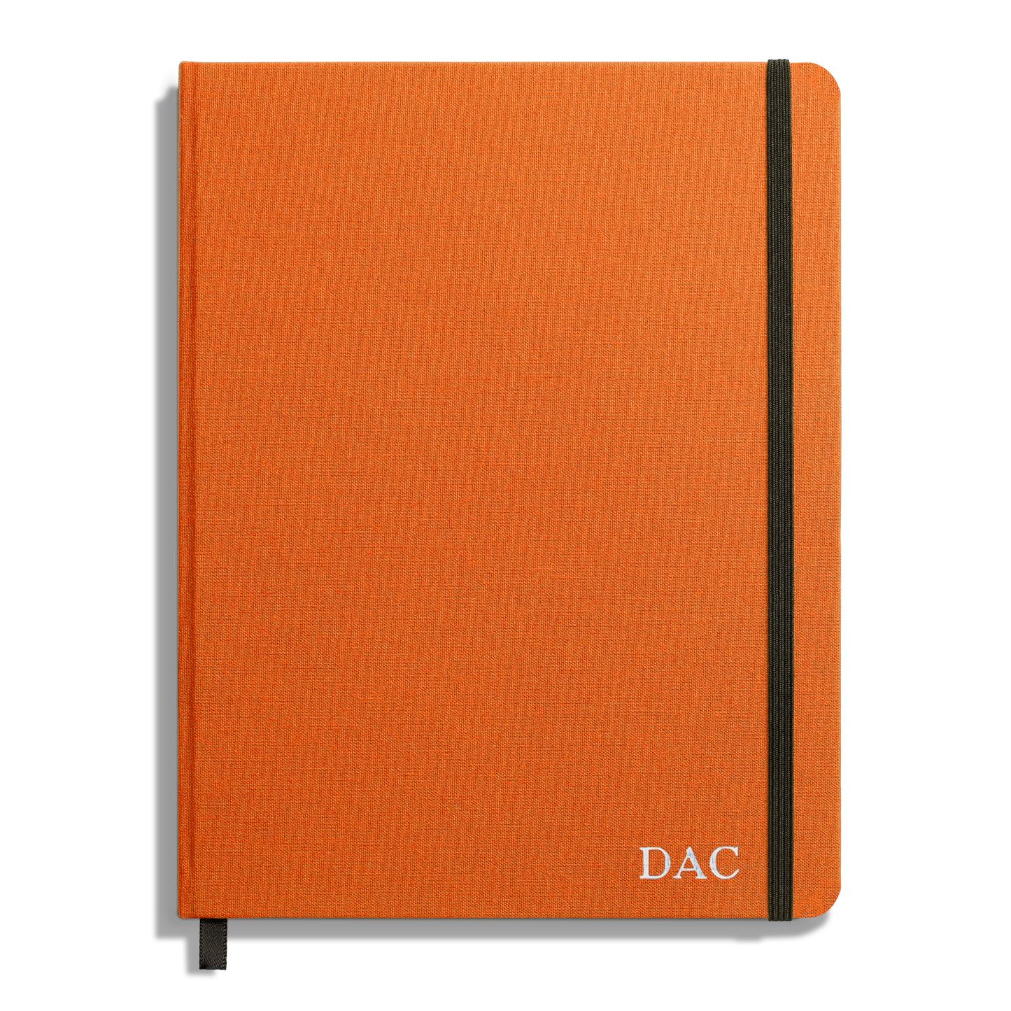 The Shinola Large Hard Ruled Journal in Bold Orange features a black elastic band, ribbon bookmark, and DAC initials in white at the bottom right. Crafted with acid-free paper for lasting notes.