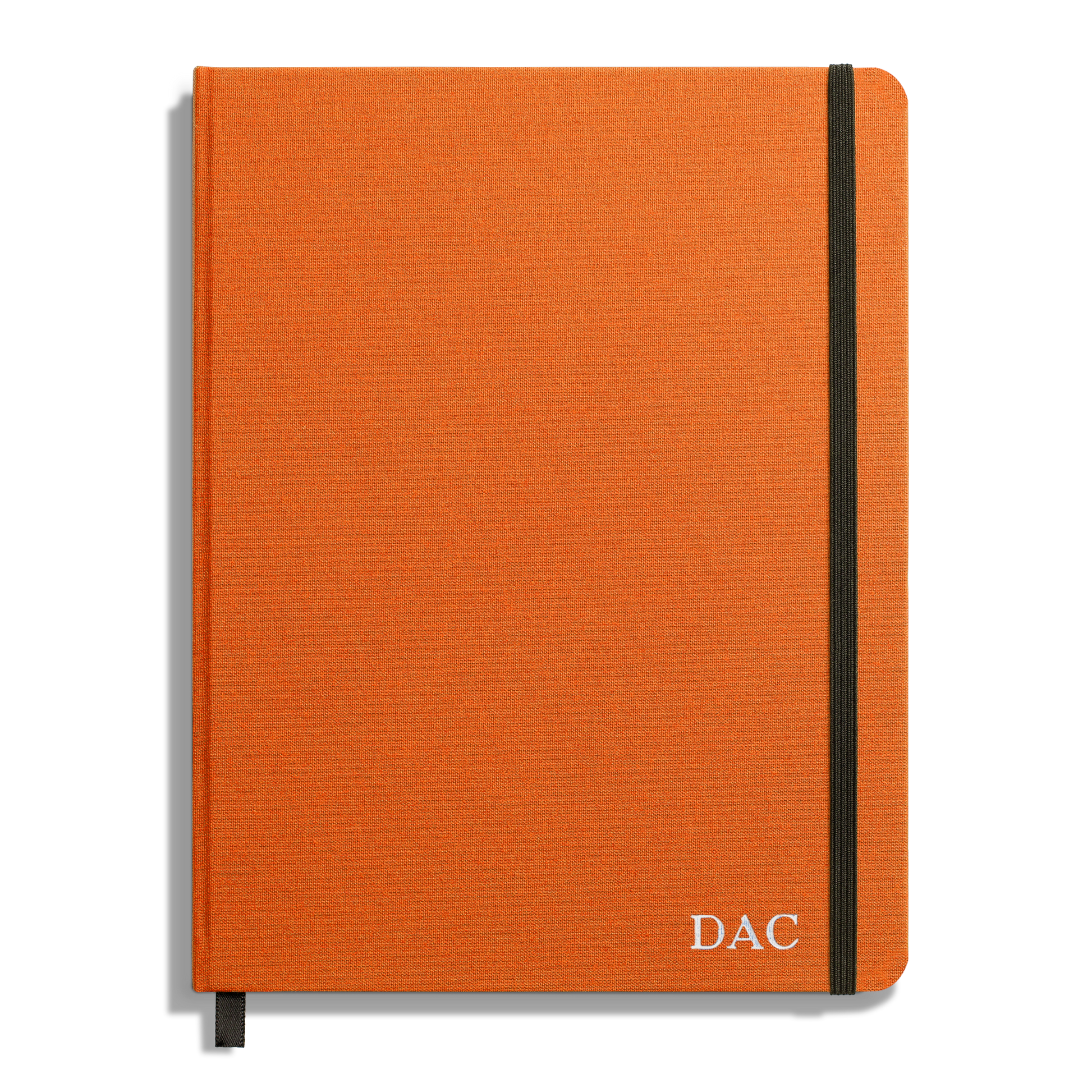 The Shinola Large Hard Ruled Journal in Bold Orange features a black elastic band, ribbon bookmark, and DAC initials in white at the bottom right. Crafted with acid-free paper for lasting notes.