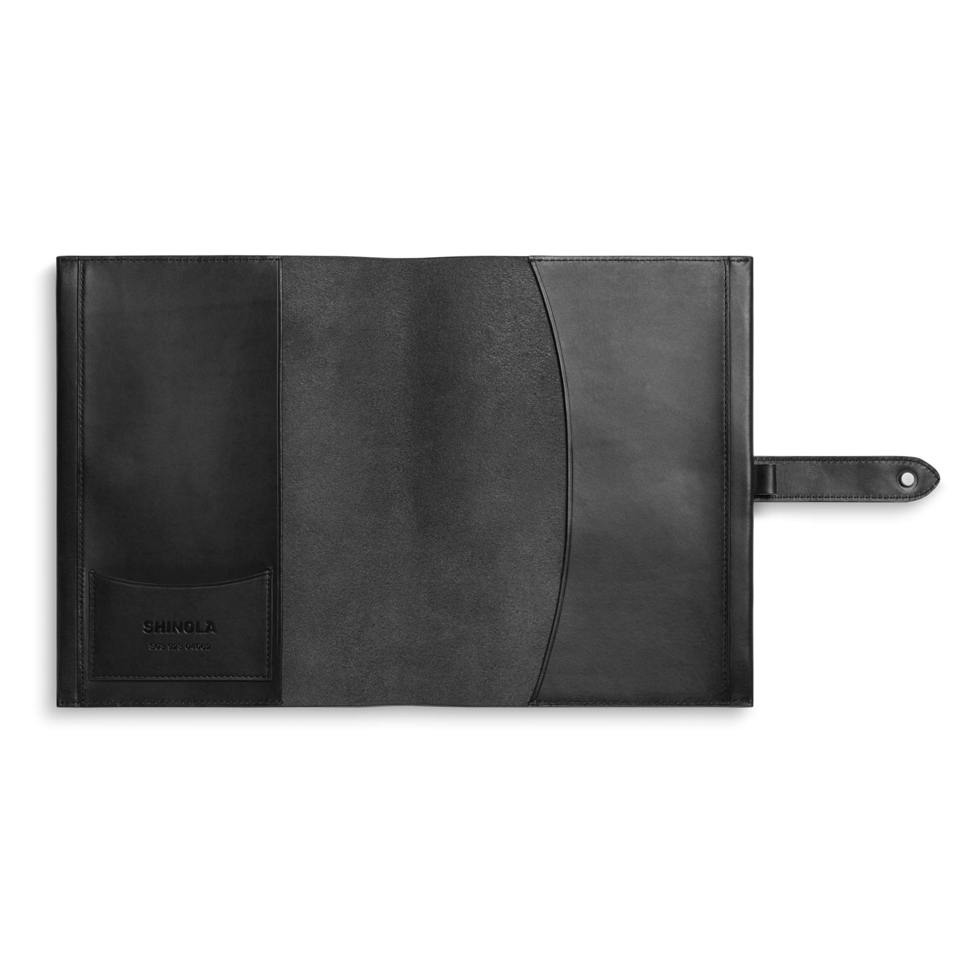 The Shinola Large Journal Cover in black Italian Vachetta leather features interior pockets (one with the Shinola logo) and a right-side tab closure. This sleek, minimal cover is perfect for organizing papers or notebooks.